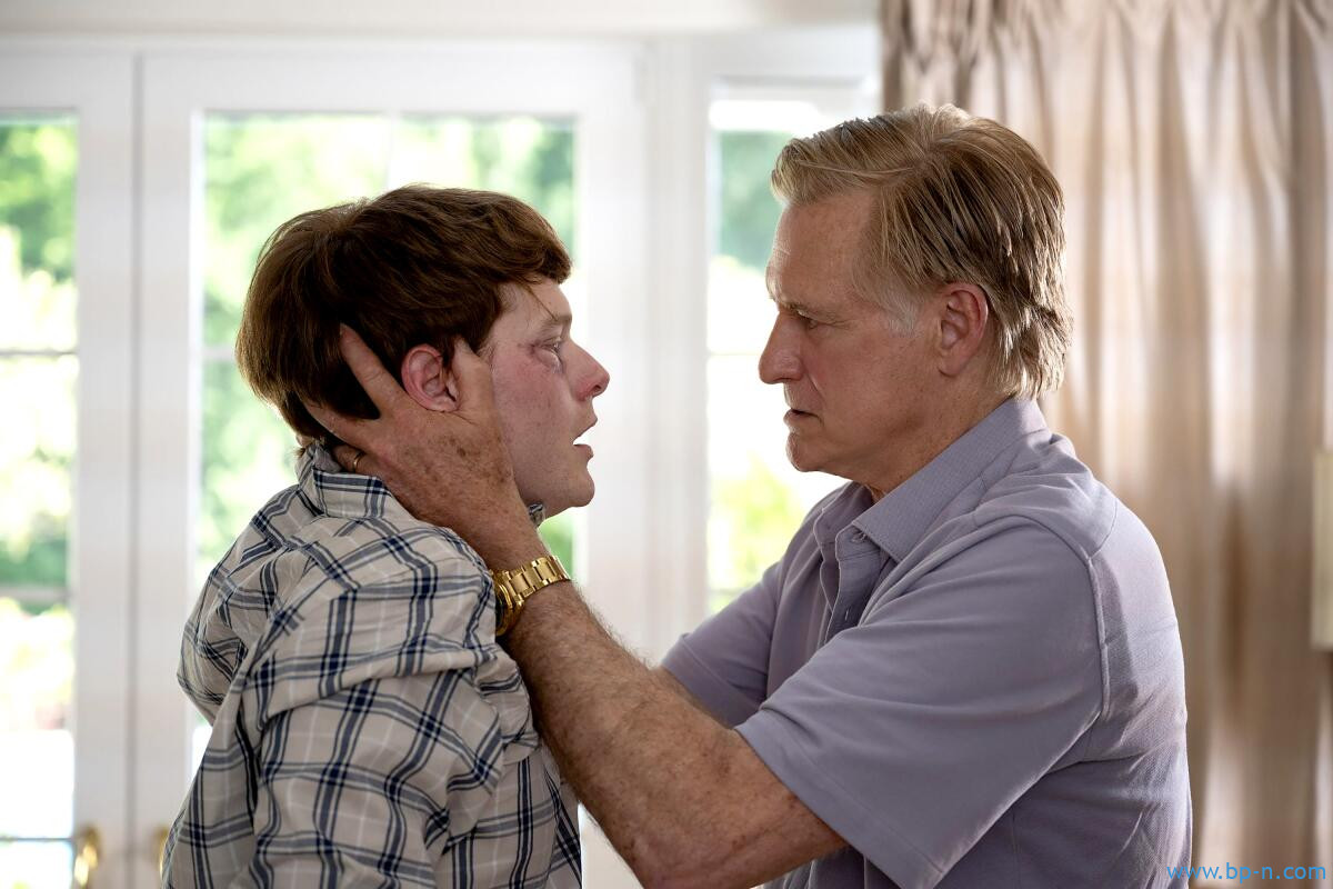 A young man looks scared as an older man grasps his head in his hands in "Murdaugh Murders: The Movie." 